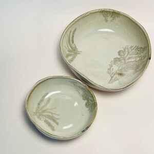 Handmade porcelain nesting bowls with evergreen motif, set of two